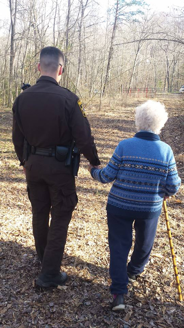 cop walking elderly home