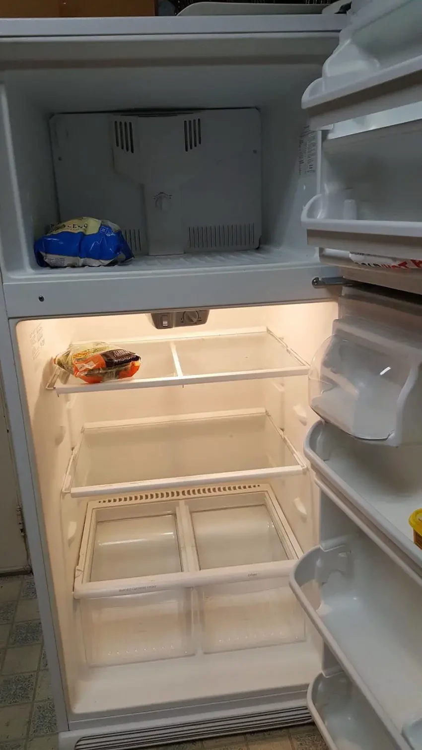 man with empty fridge
