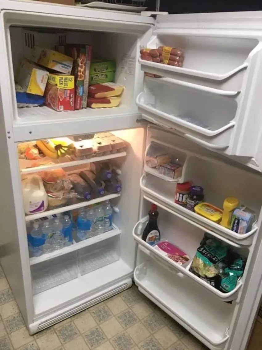 man with empty fridge