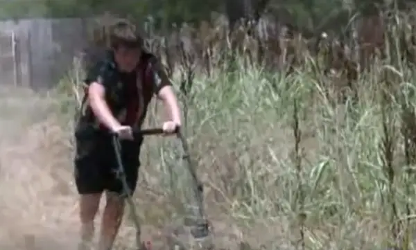 boys mowing yard