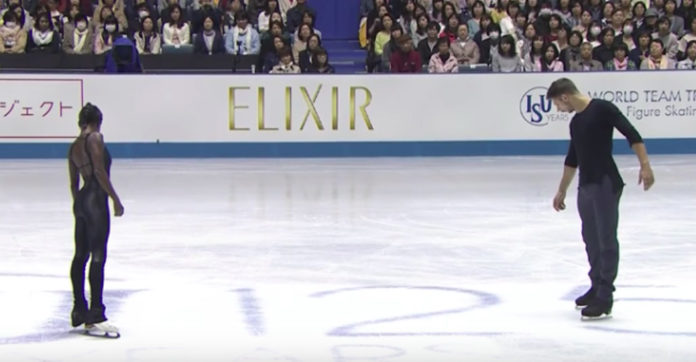 two-skaters-stand-in-formation