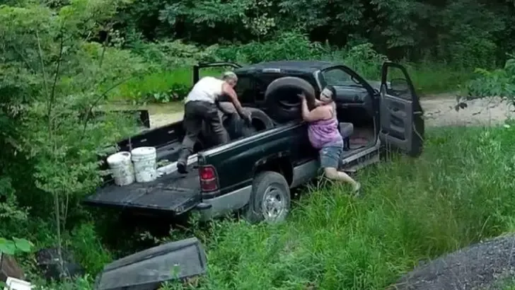 couple dumping trash wildlife preserve