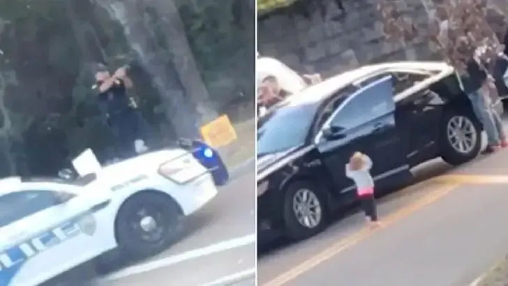 toddler walks towards police hands up
